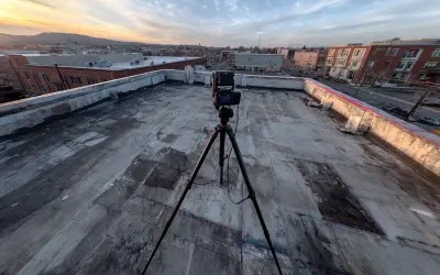 Survey equipment on rooftop for telecommunications inspection